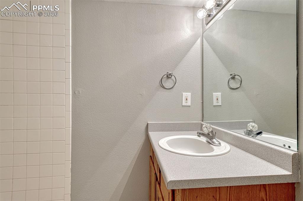 2580 Malpaso Point Colorado Springs, CO 80922 - Photo 19 of 23 a bathroom with a sink and a mirror
