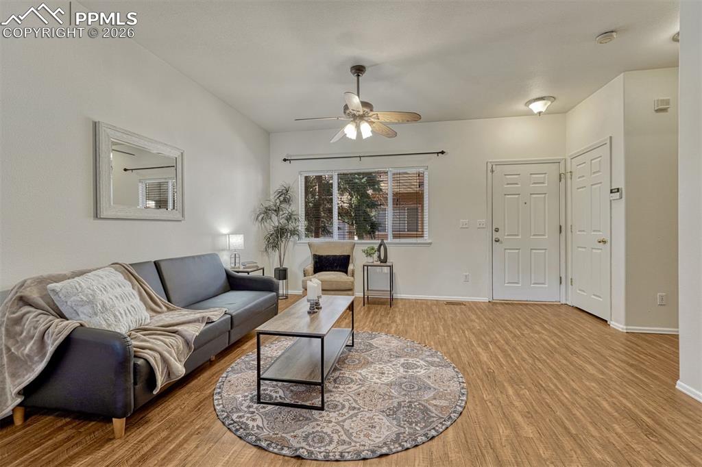 2580 Malpaso Point Colorado Springs, CO 80922 - Photo 3 of 23 a living room with furniture and a wooden floor