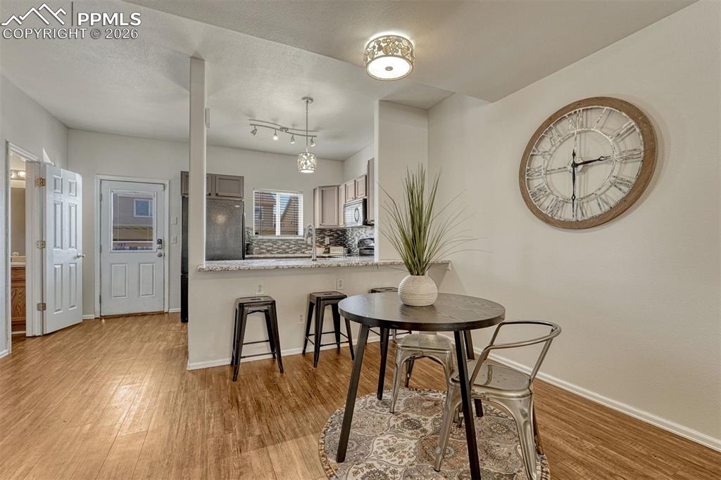 2580 Malpaso Point Colorado Springs, CO 80922 - Photo 5 of 23 a view of a dining room with furniture and wooden floor