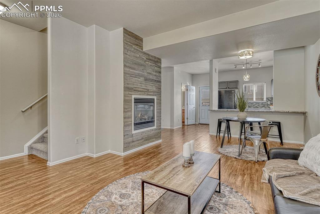 2580 Malpaso Point Colorado Springs, CO 80922 - Photo 6 of 23 a living room with furniture and a wooden floor