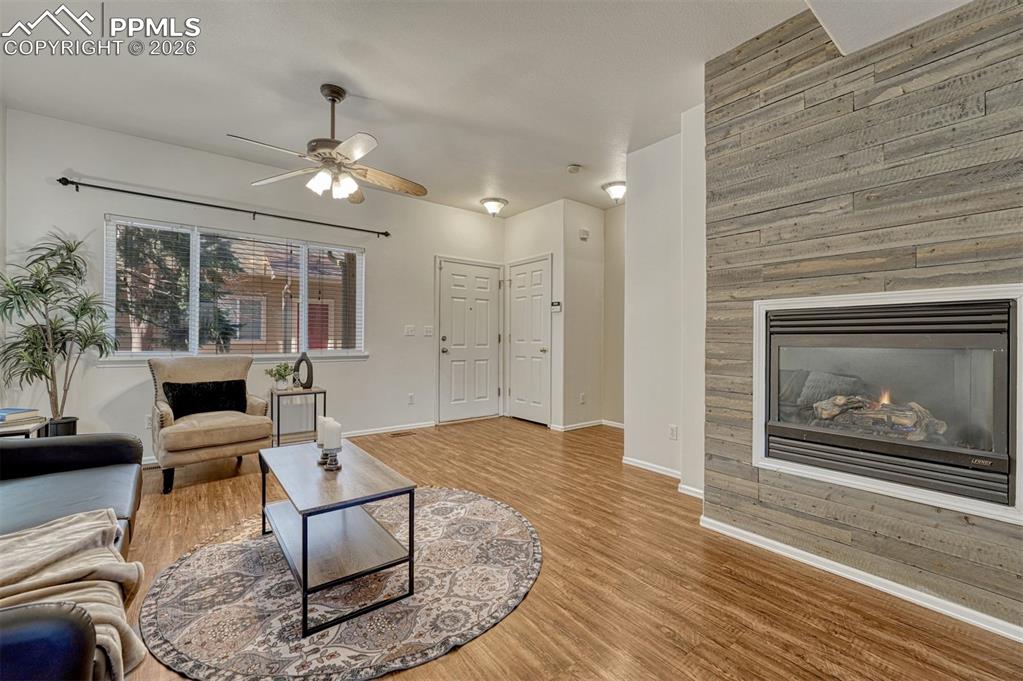2580 Malpaso Point Colorado Springs, CO 80922 - Photo 7 of 23 a living room with furniture a rug and a fireplace