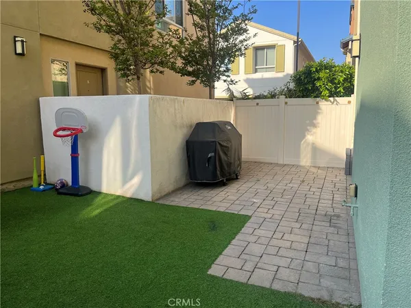 a backyard of a house with table and chairs