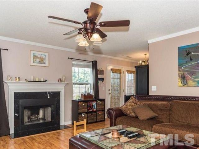 7332 Brighton Hill Lane Raleigh, NC 27616 - Photo 2 of 3 a living room with furniture and a fireplace