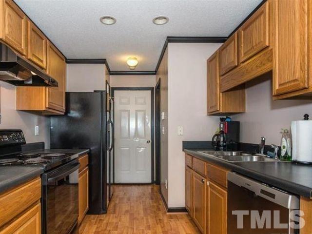 7332 Brighton Hill Lane Raleigh, NC 27616 - Photo 3 of 3 a kitchen with stainless steel appliances granite countertop a refrigerator a sink dishwasher a stove and white countertops with wooden floor