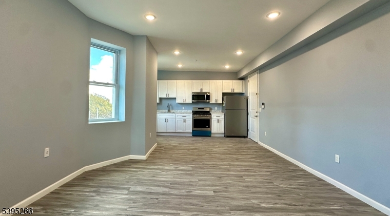 155 Clifton Avenue, Unit 3RR Newark, NJ 07104 - Photo 3 of 13 a view of a kitchen with stainless steel appliances granite countertop a refrigerator and a sink