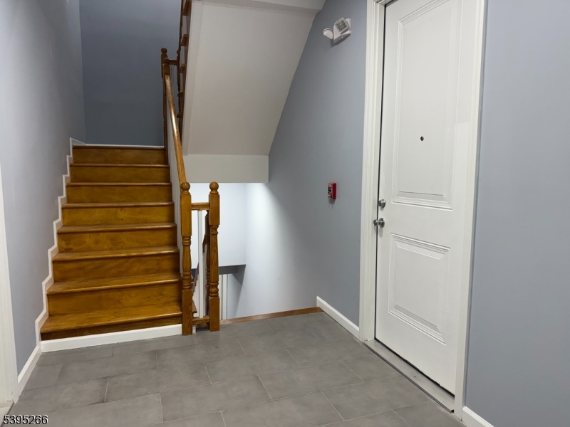 155 Clifton Avenue, Unit 3RR Newark, NJ 07104 - Photo 10 of 13 a view of an empty room with stairs