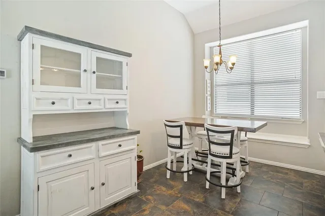a kitchen with cabinets and window