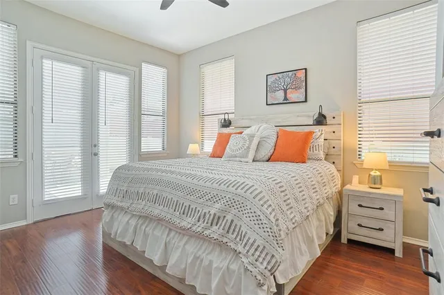 a bedroom with a bed and a flat tv screen on dresser