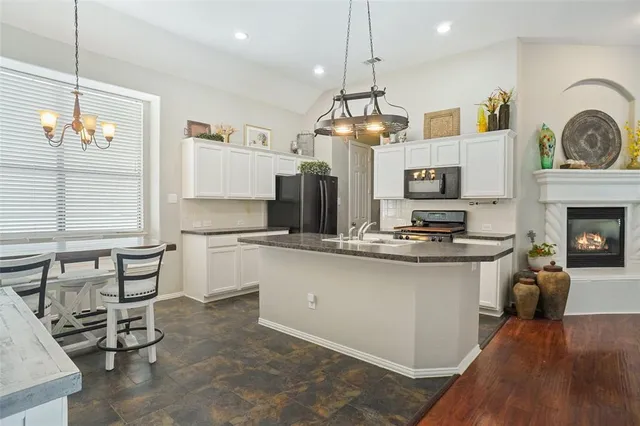 a open kitchen with sink cabinets and wooden floor