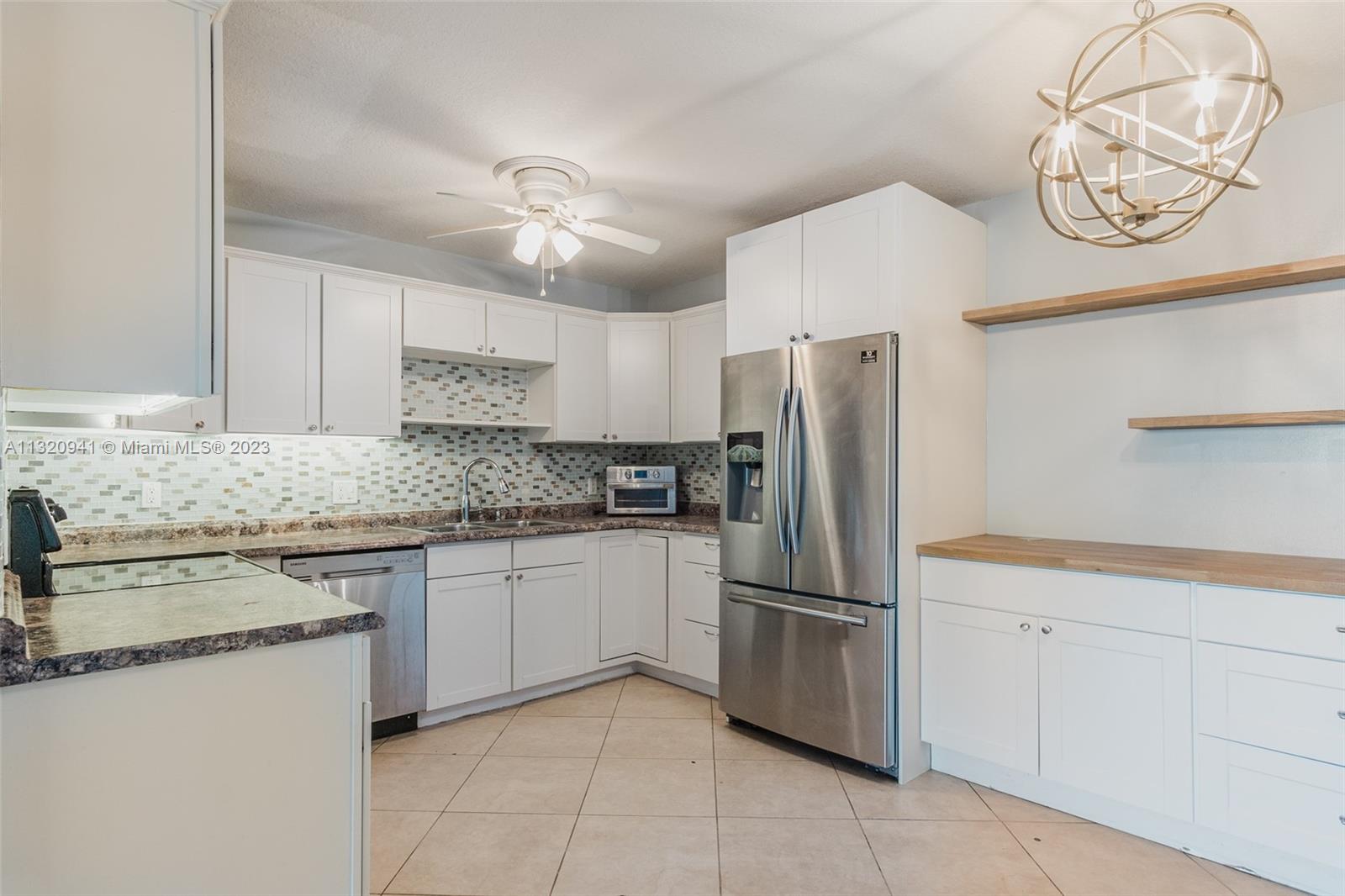 Jacaranda Plantation, FL 33324 - Photo 1 of 22 a kitchen with stainless steel appliances granite countertop a refrigerator sink and cabinets