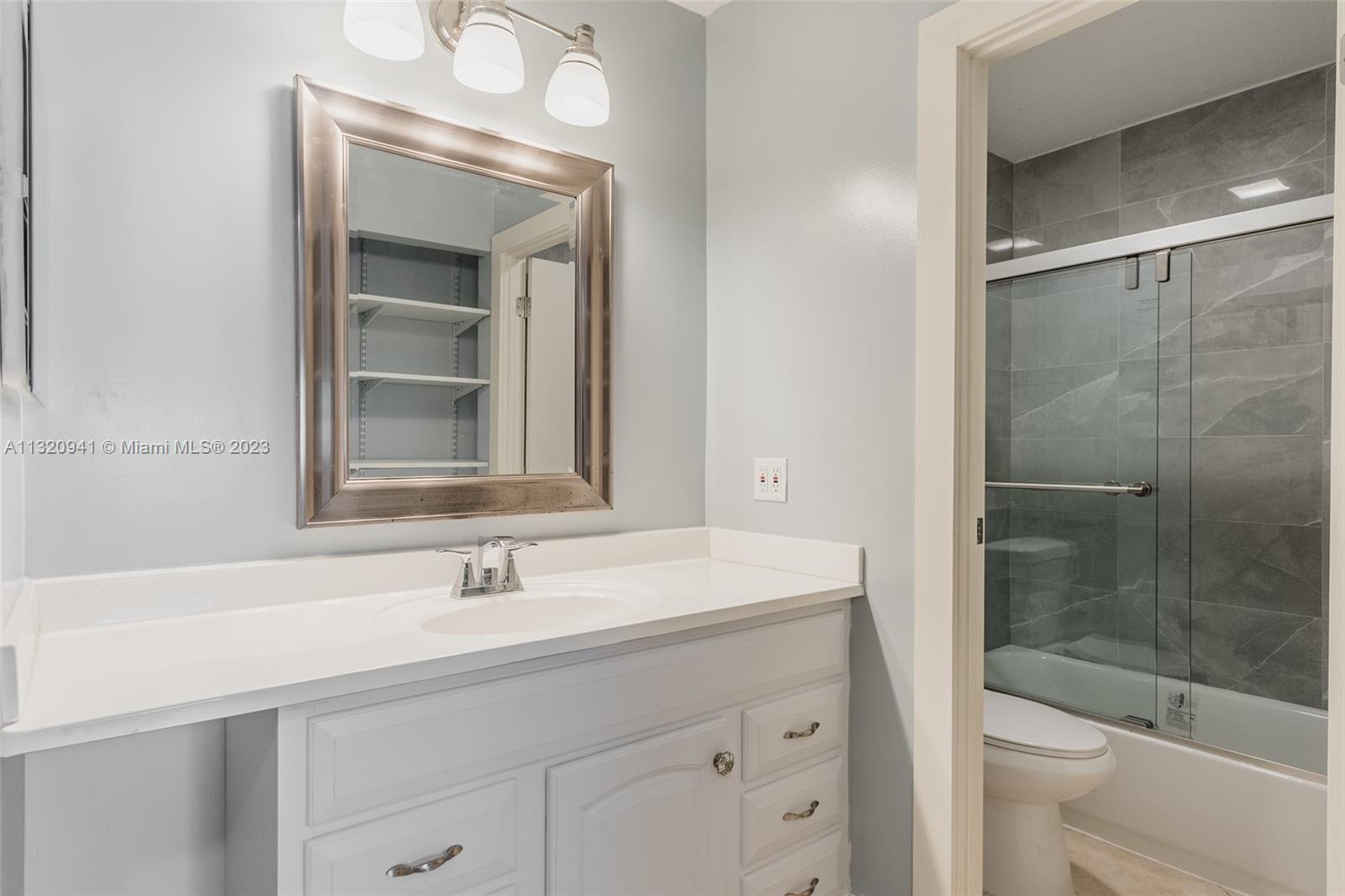 Jacaranda Plantation, FL 33324 - Photo 13 of 22 a bathroom with a sink shower and a mirror