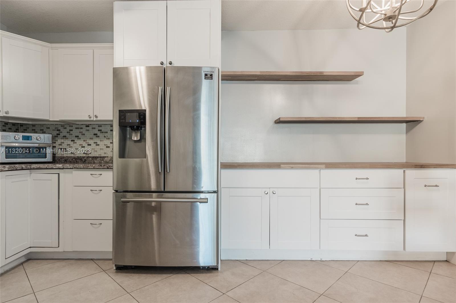 Jacaranda Plantation, FL 33324 - Photo 3 of 22 a metallic refrigerator freezer sitting in a kitchen