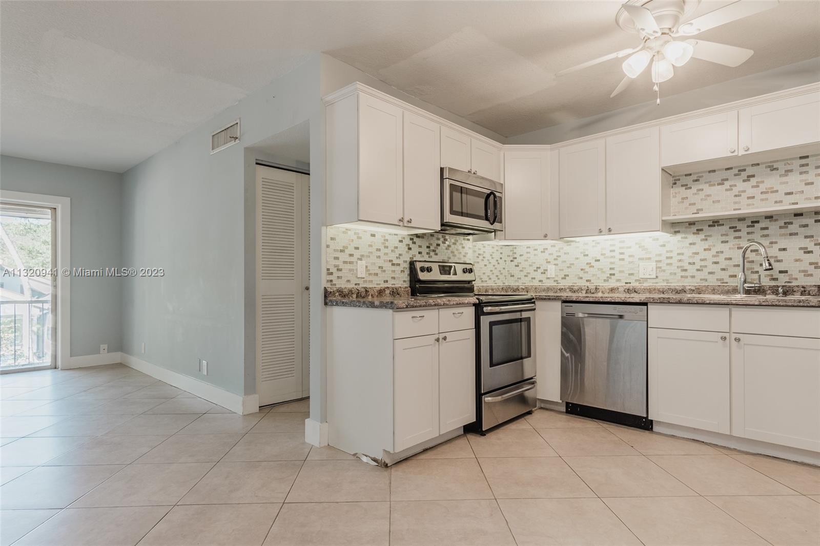 Jacaranda Plantation, FL 33324 - Photo 4 of 22 a kitchen with stainless steel appliances granite countertop a stove and a sink