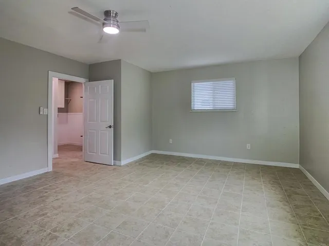 an empty room with closet and natural light