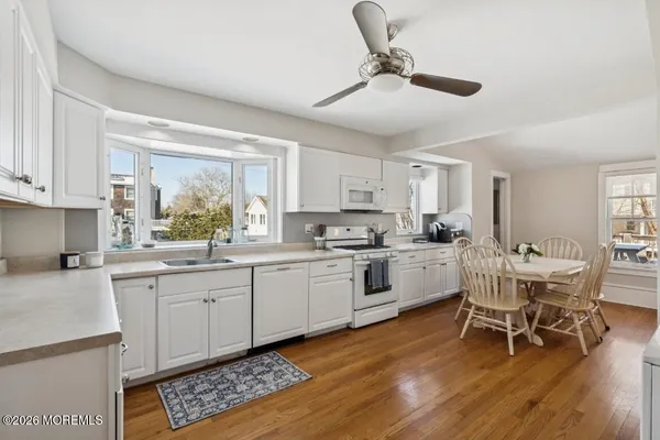 a kitchen with sink cabinets and dining table