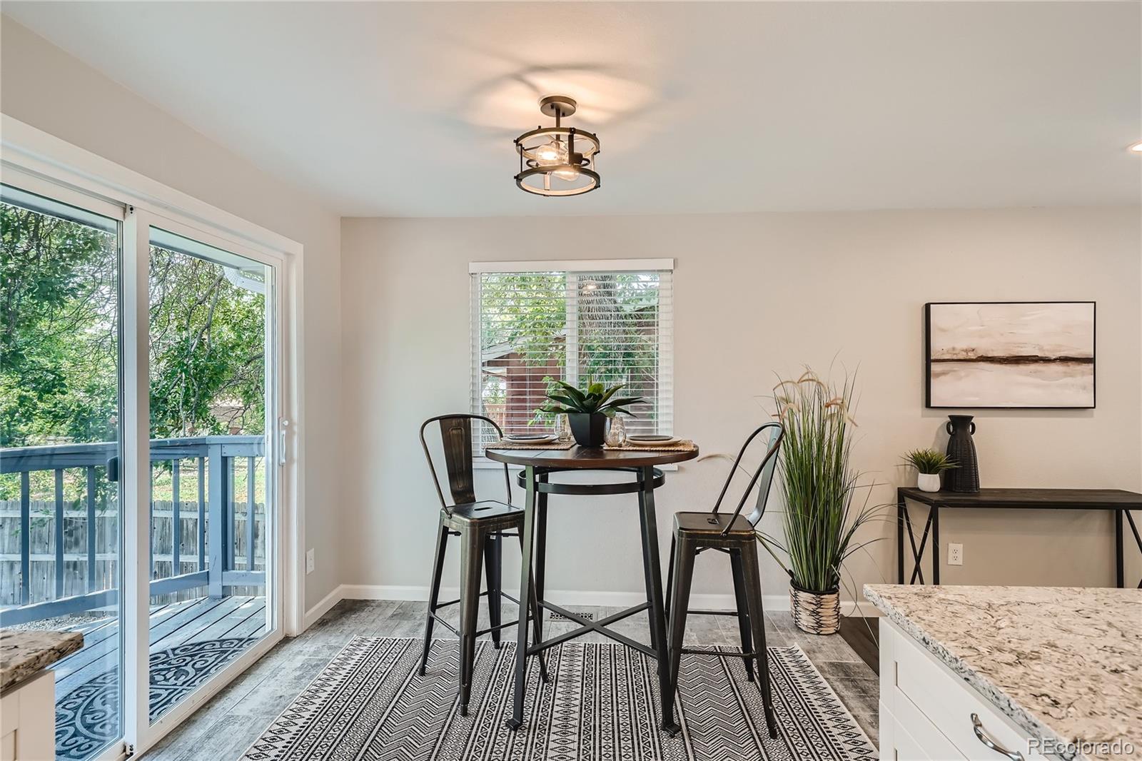 8506 Eaton Street Arvada, CO 80003 - Photo 11 of 28 a view of a dining room with furniture window and outside view