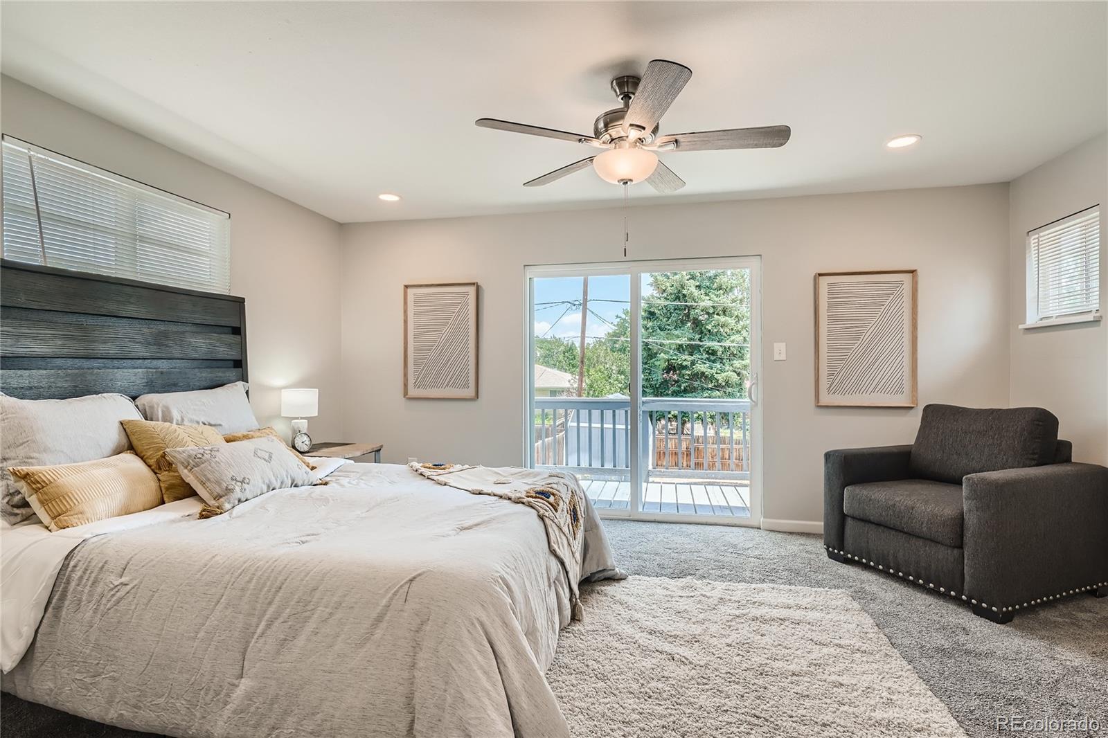 8506 Eaton Street Arvada, CO 80003 - Photo 13 of 28 a bedroom with a large bed and a couch