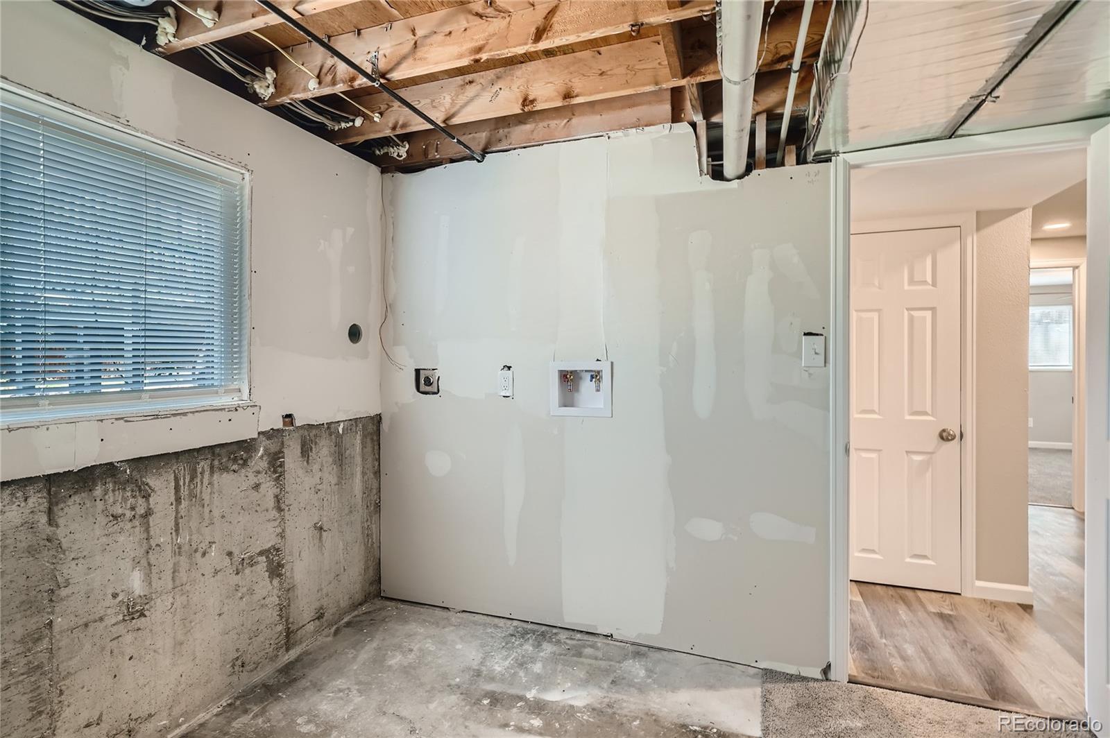 8506 Eaton Street Arvada, CO 80003 - Photo 23 of 28 a view of a bathroom with a sink and a mirror