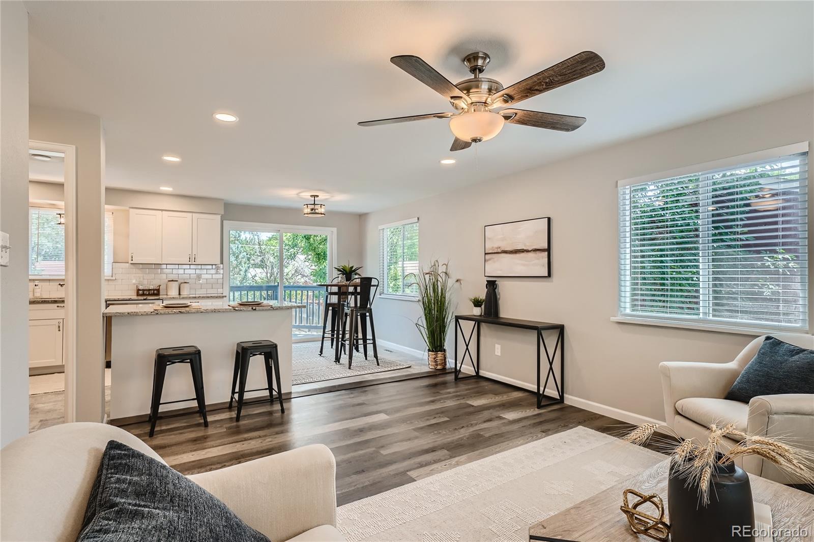8506 Eaton Street Arvada, CO 80003 - Photo 5 of 28 a living room with furniture and a wooden floor