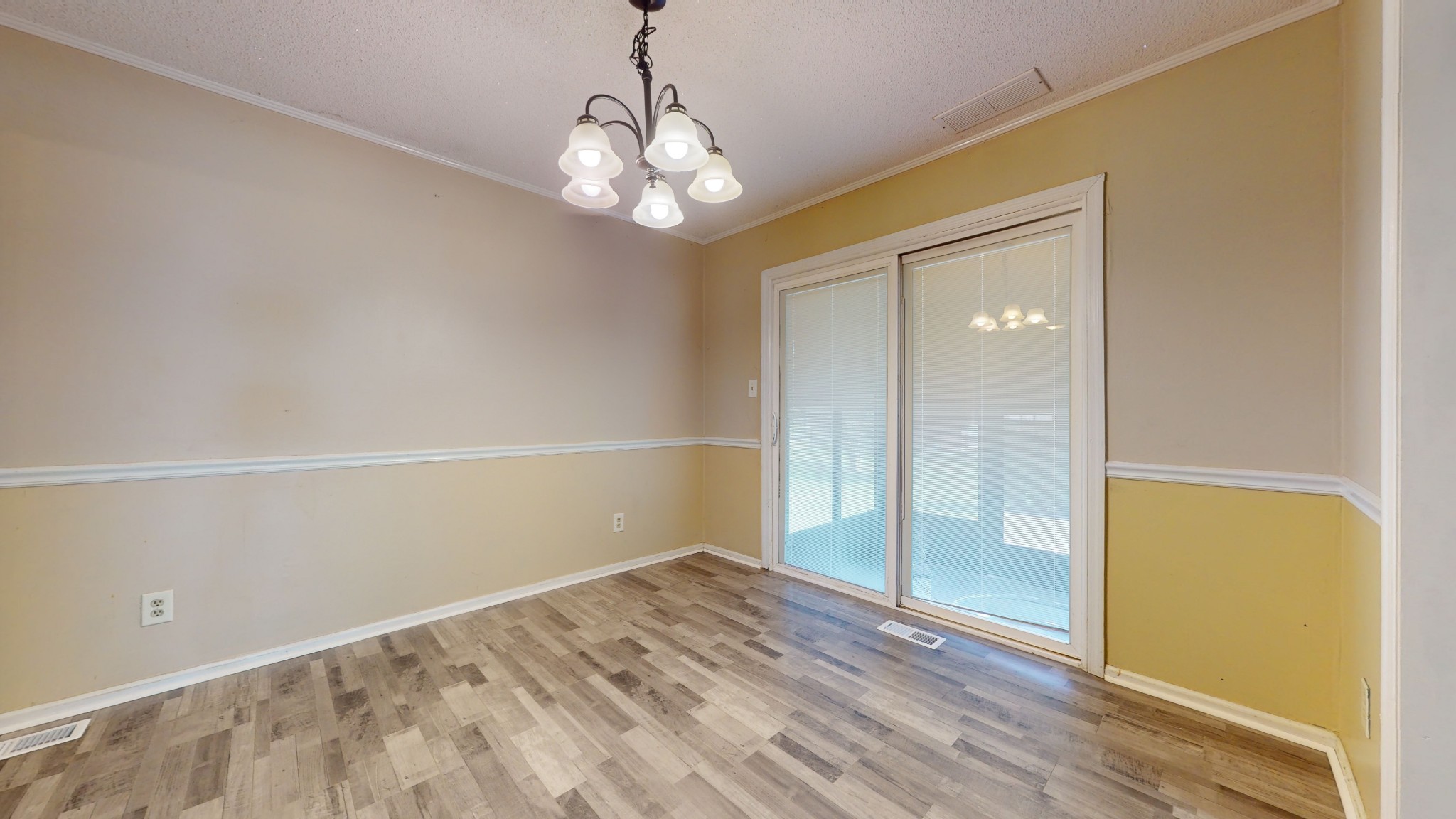 511 Limestone Road Elora, TN 37328 - Photo 16 of 55 en empty room with wooden floor and chandelier