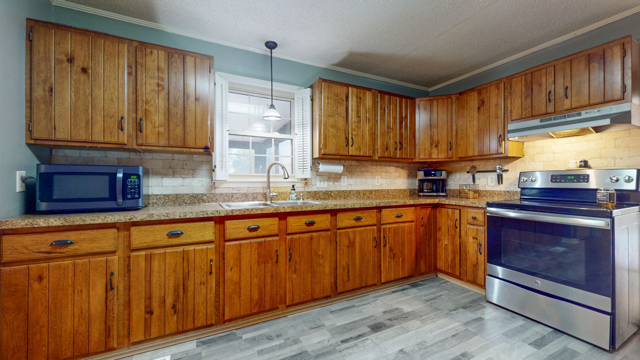 511 Limestone Road Elora, TN 37328 - Photo 20 of 55 a kitchen with granite countertop wooden cabinets stainless steel appliances a sink and a window