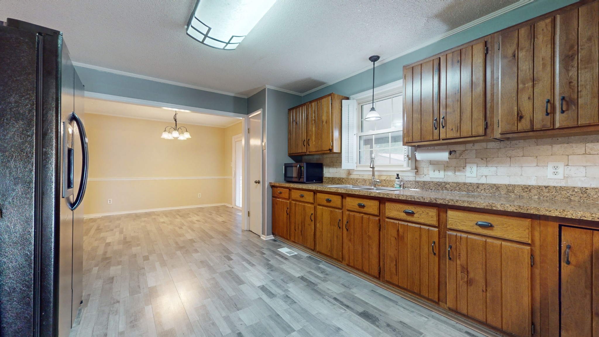 511 Limestone Road Elora, TN 37328 - Photo 21 of 55 a kitchen with granite countertop wooden cabinets a sink and a stainless steel appliances