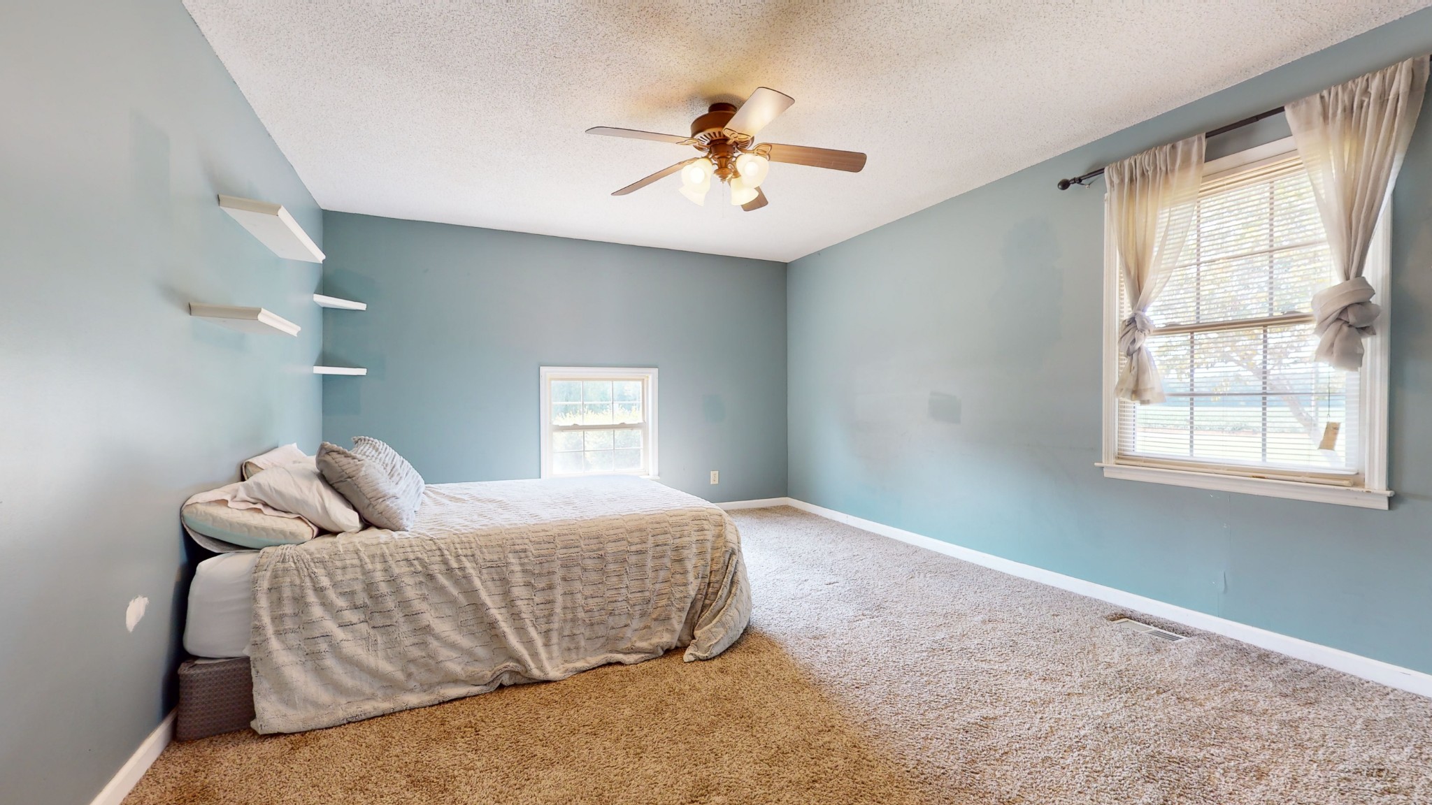 511 Limestone Road Elora, TN 37328 - Photo 24 of 55 a bedroom with a large bed and a chandelier fan