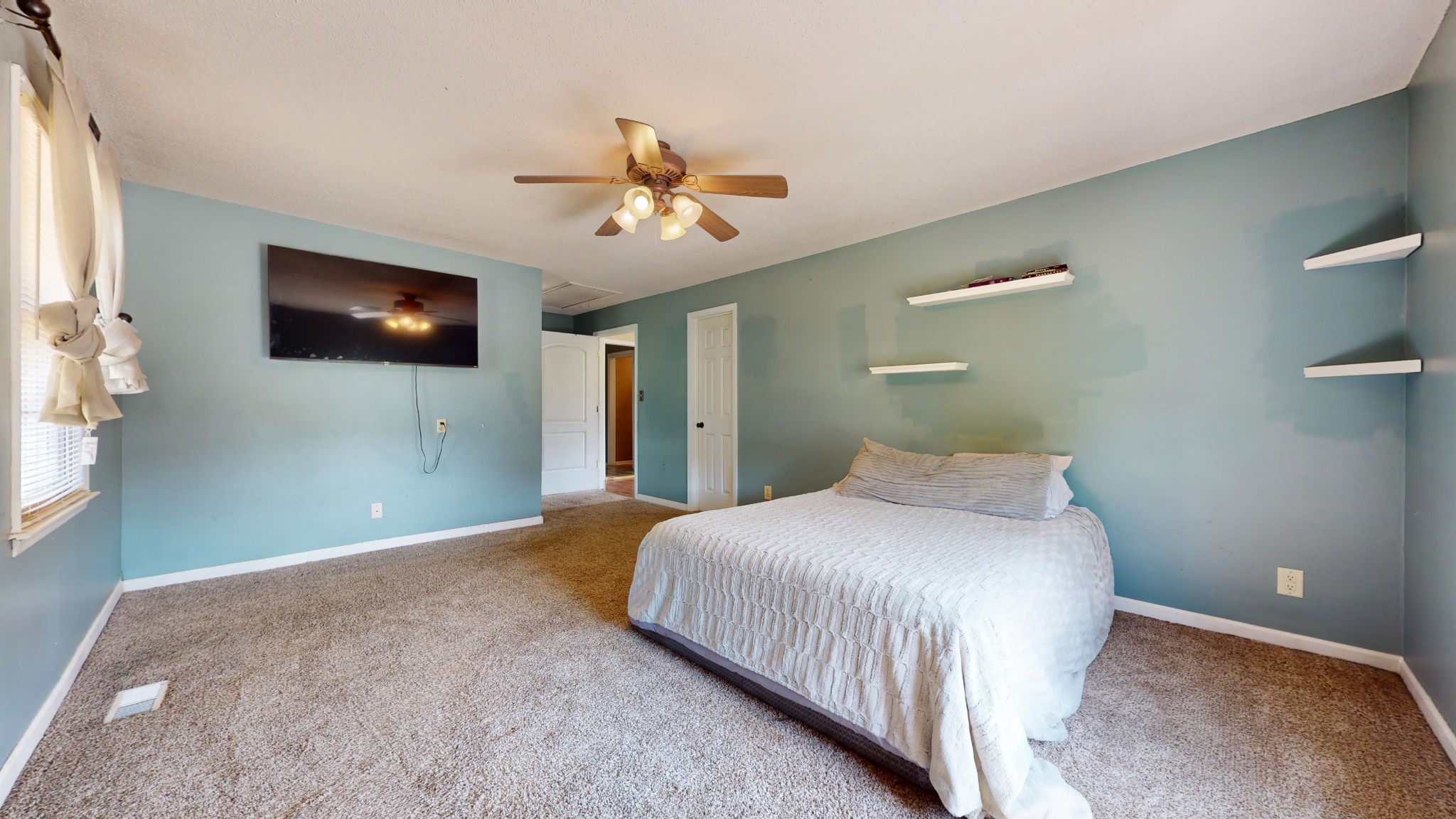 511 Limestone Road Elora, TN 37328 - Photo 26 of 55 a bedroom with a large bed and a flat screen tv