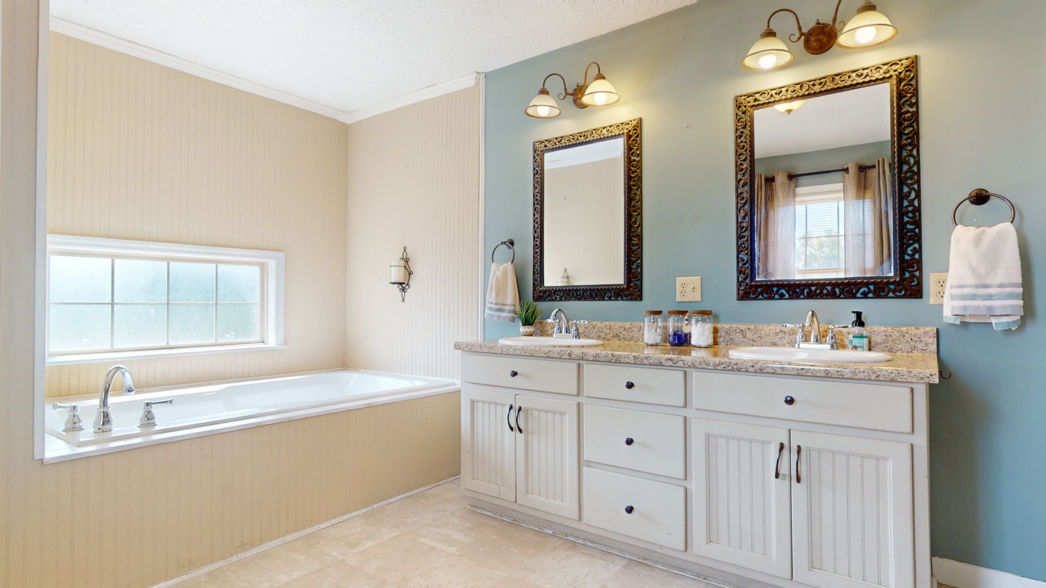 511 Limestone Road Elora, TN 37328 - Photo 29 of 55 a bathroom with a double vanity sink a mirror and a bathtub