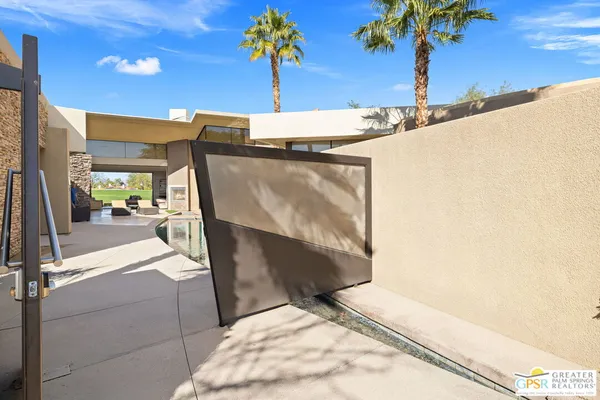 a kitchen with stainless steel appliances granite countertop a stove and a view of living room