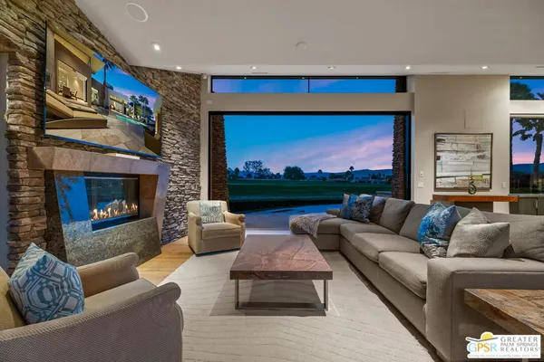 a large kitchen with stainless steel appliances microwave a dining table and chairs