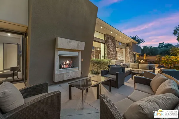 a view of a patio with a table and chairs