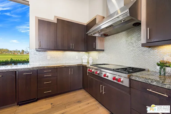 a living room with furniture wooden floor and a fireplace