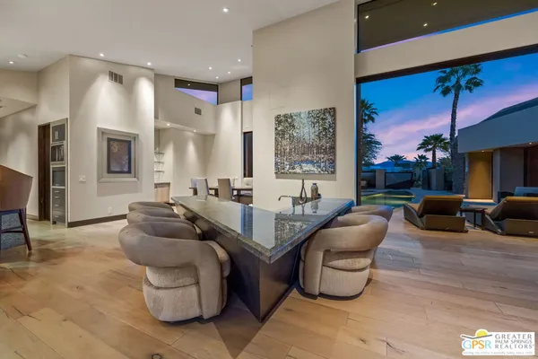 a view of a swimming pool and lounge chairs in back of a lake