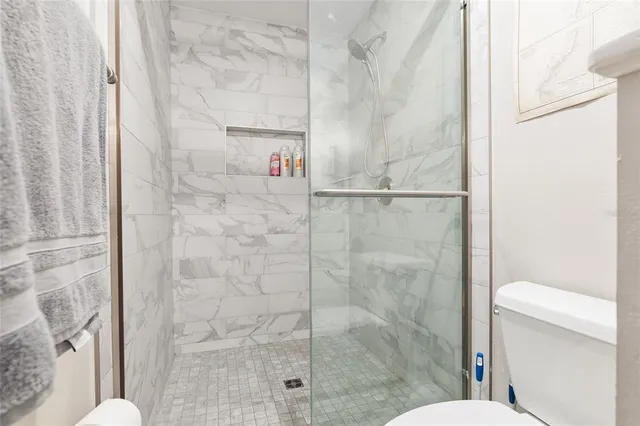 a view of a house with backyard and a tree