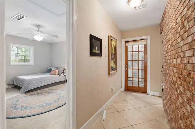 an aerial view of residential house with outdoor space and trees all around