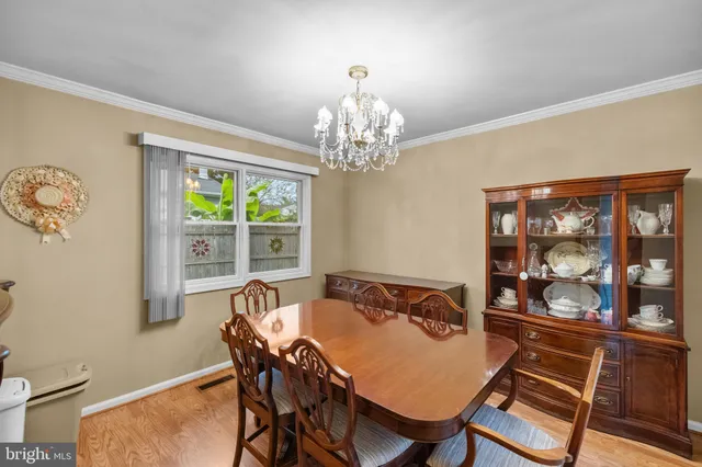 a view of a dining room with furniture wooden floor and a chandelier
