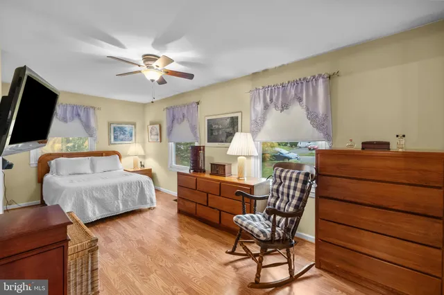 a bedroom with furniture and wooden floor