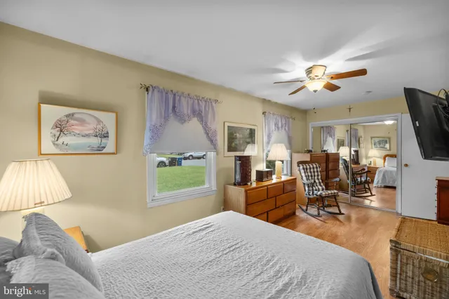 a bedroom with a bed a flat screen tv and couches