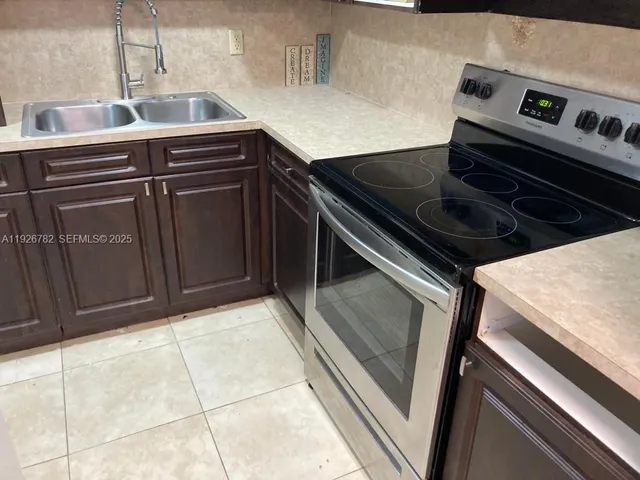 a kitchen with stove and cabinets