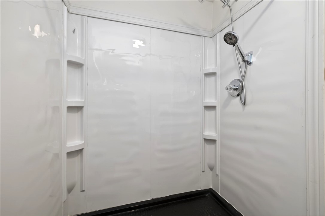 2684 Arthur Road Springfield, OH 45502 - Photo 35 of 69 This clean shower features ample shelving for bath essentials, ensuring convenience and style.