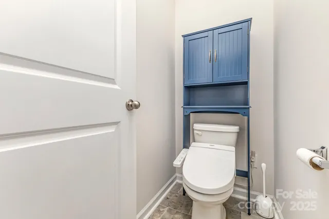 a bedroom with a bed and a lamp on desk