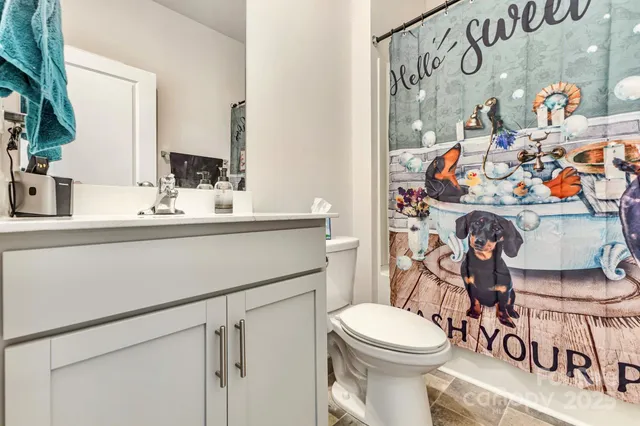 a view of a bedroom with a bed and a window