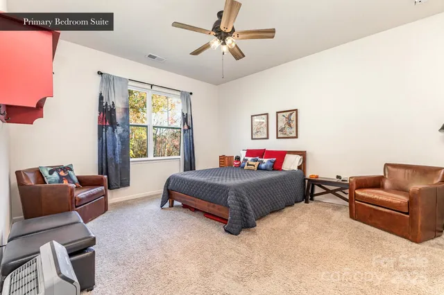 a bedroom with furniture and a chandelier