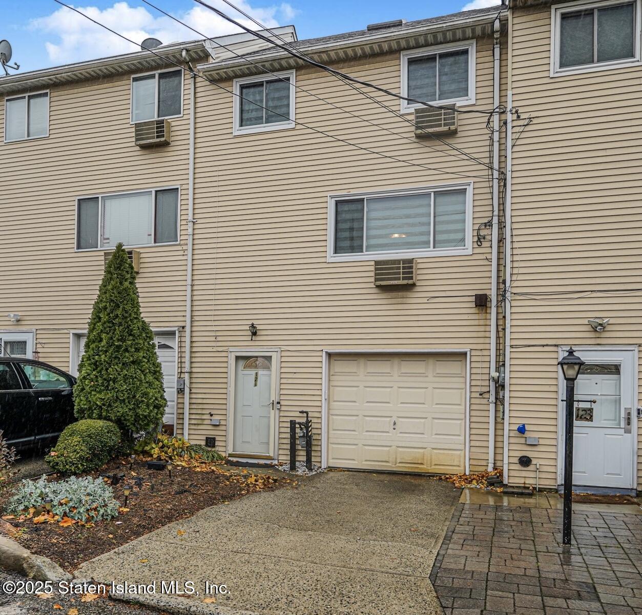 121 Clark Lane Staten Island, NY 10304 - Photo 1 of 18 a view of a house with a yard and garage