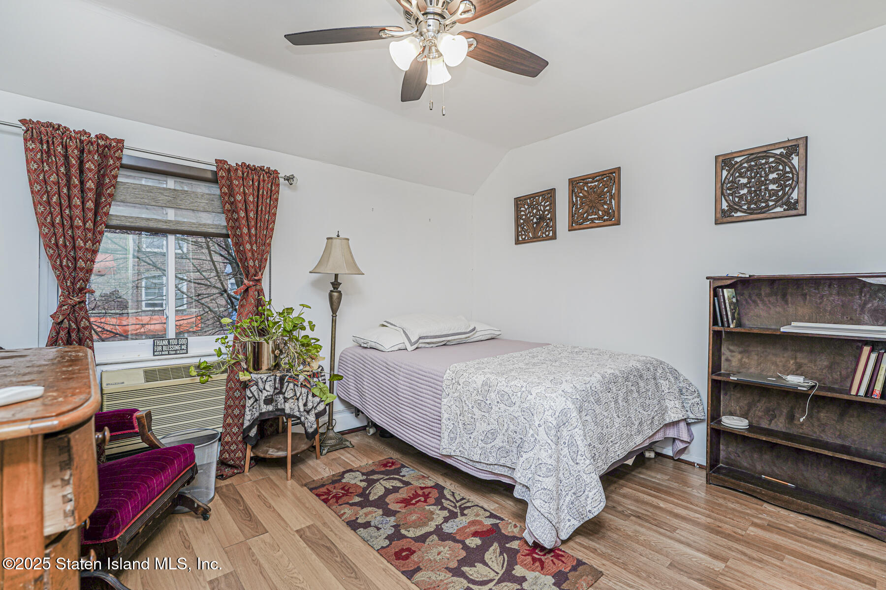 121 Clark Lane Staten Island, NY 10304 - Photo 12 of 18 a bed sitting in a room next to a window