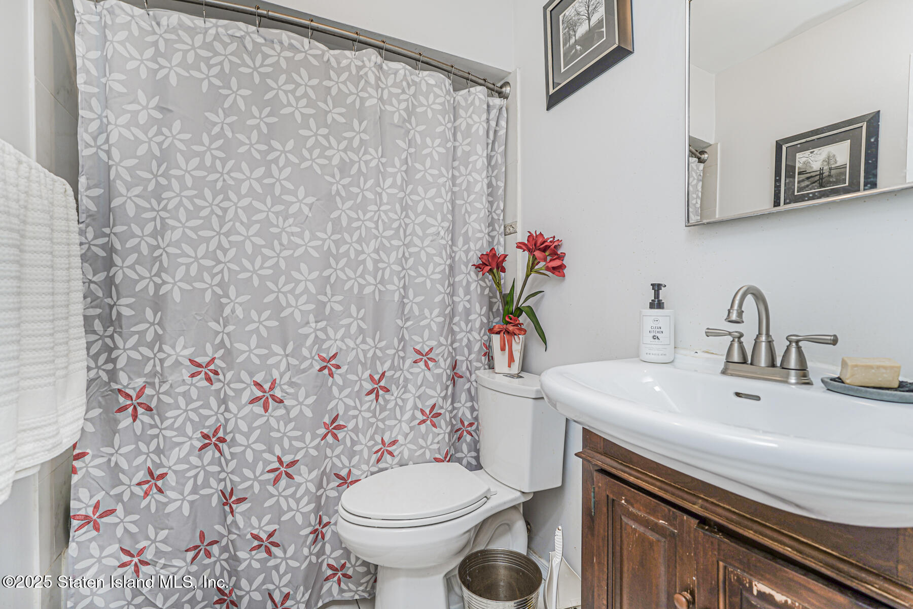 121 Clark Lane Staten Island, NY 10304 - Photo 15 of 18 a bathroom with a sink toilet and a mirror