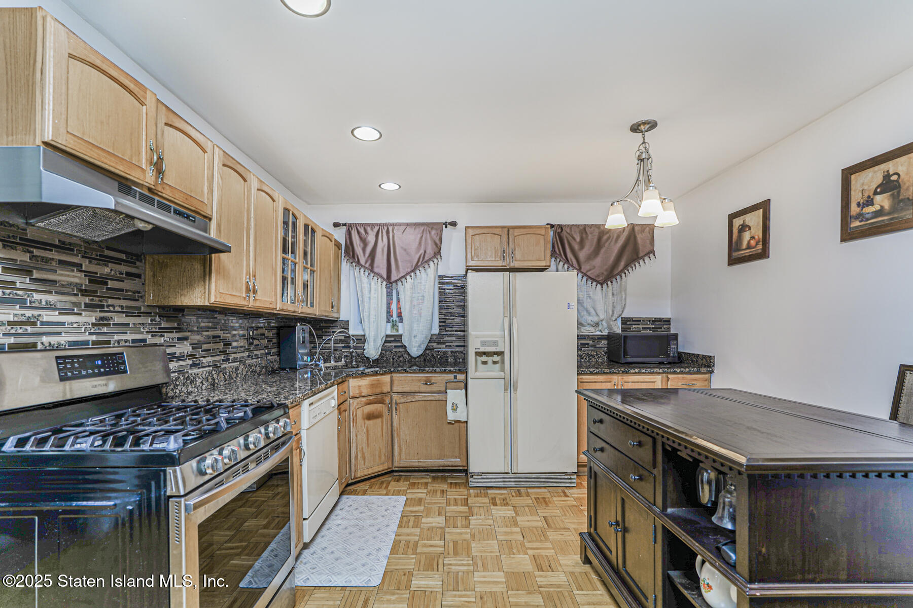 121 Clark Lane Staten Island, NY 10304 - Photo 2 of 18 a kitchen with a stove a refrigerator and cabinets