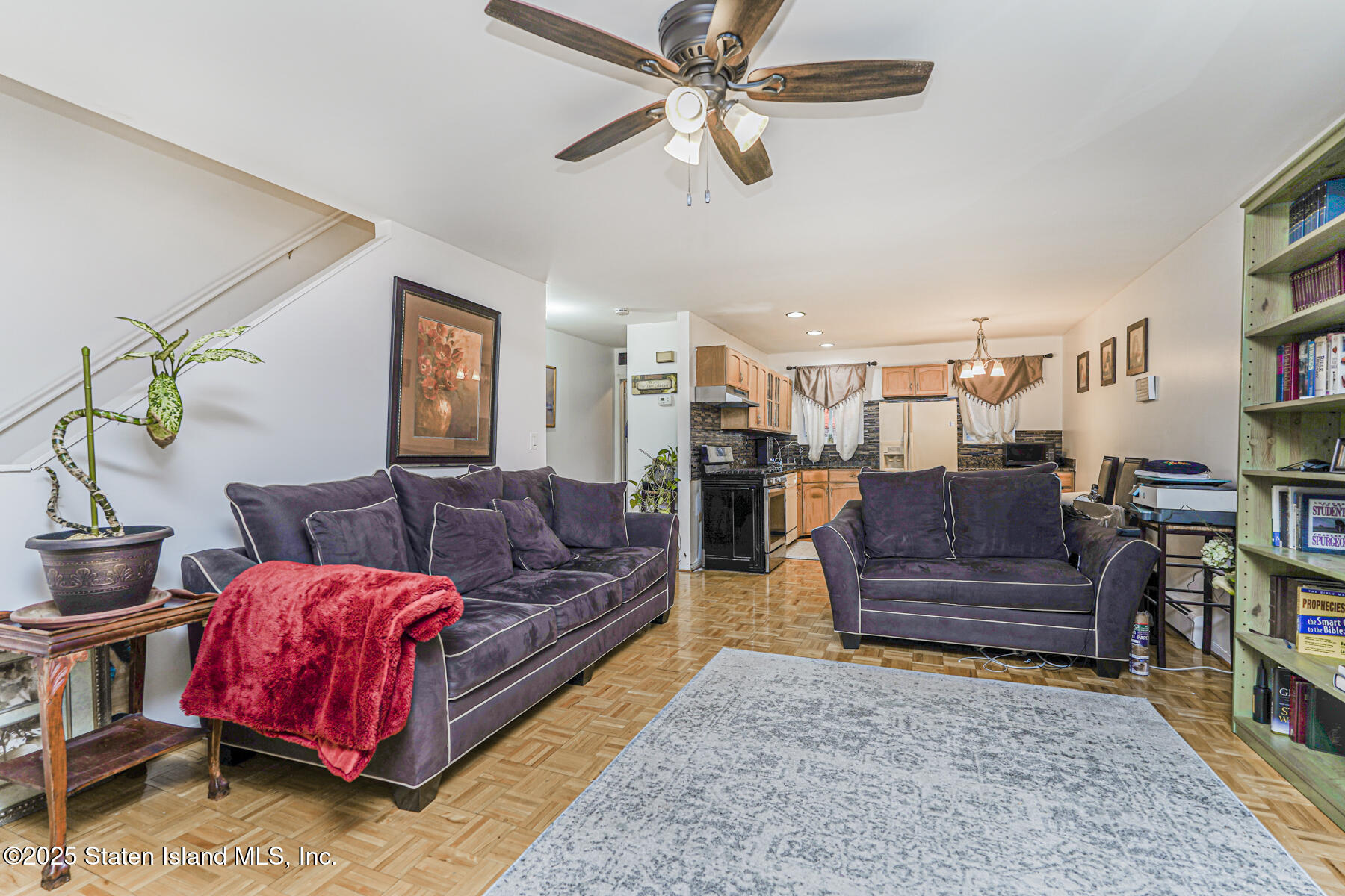 121 Clark Lane Staten Island, NY 10304 - Photo 5 of 18 a living room with furniture ceiling fan and a rug