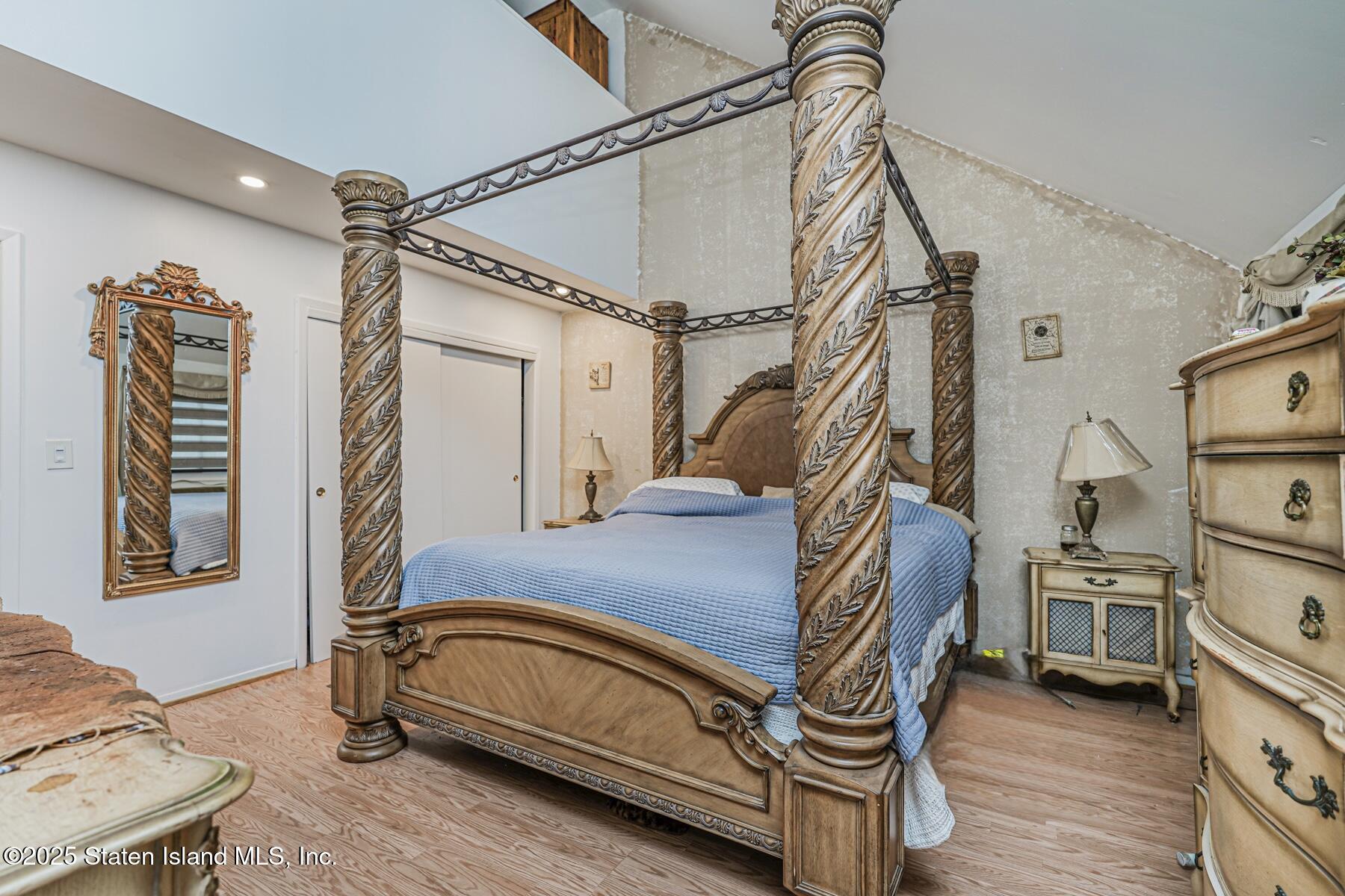 121 Clark Lane Staten Island, NY 10304 - Photo 8 of 18 a bedroom with a bed and a book shelf